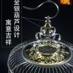 Stainless bird cage with intricate gold and silver decorative top design